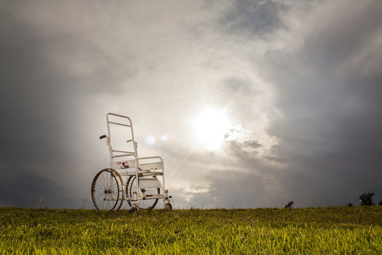 a wheelchair stands alone on a hill